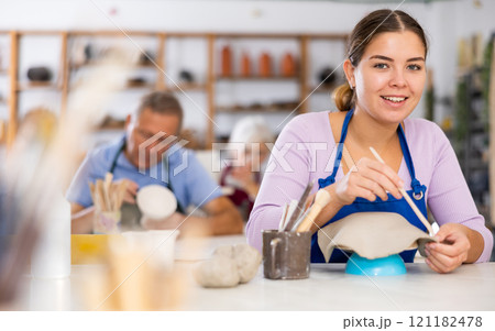 girl processes clay billet girl processes clay billet 121182478