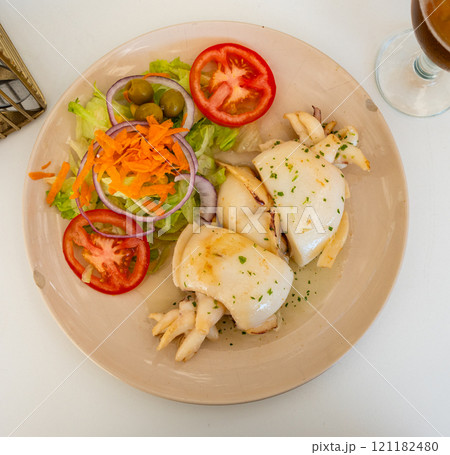 Grilled sepia with vegetable salad of greens, tomatoes, carrots and corn Grilled sepia with vegetable salad of greens, tomatoes, carrots and corn 121182480