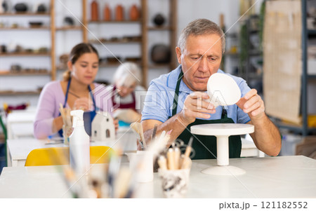 man potter carefully paints vase man potter carefully paints vase 121182552