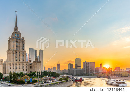 High-rise stalinist building near river at summer sunset in Moscow, Russia. Historic name is Hotel Ukraine. 121184434