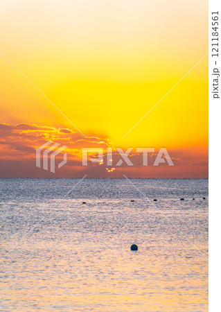 Beautiful yellow and orange sunrise over the sea. Beautiful yellow and orange sunrise over the sea. 121184561