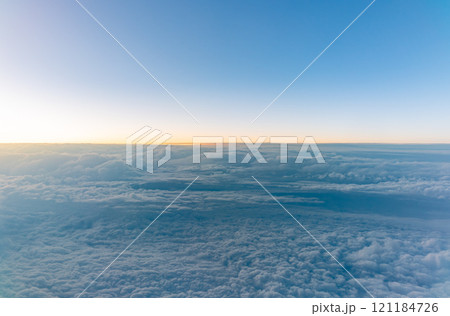Beautiful orange and pink sunrise over the clouds, view from the plane. Beautiful orange and pink sunrise over the clouds, view from the plane. 121184726