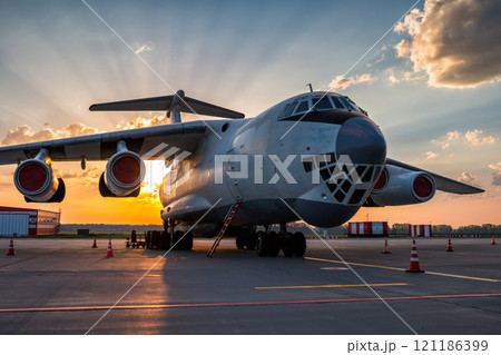 Wide body transport cargo aircraft at airport apron in the morning sun Wide body transport cargo aircraft at airport apron in the morning sun 121186399