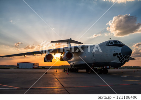 Wide body transport cargo plane at airport apron in the morning sun Wide body transport cargo plane at airport apron in the morning sun 121186400