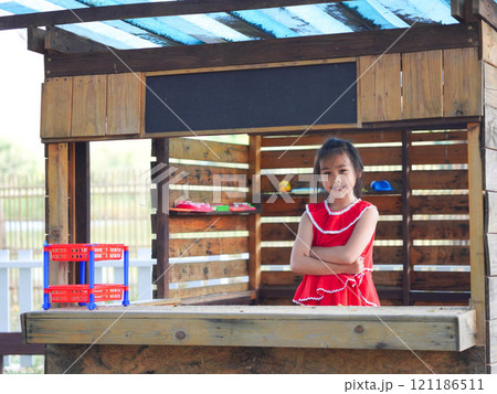 Cute girl playing in the playground during summer vacation. Happy children having fun in an outdoor park. 121186511