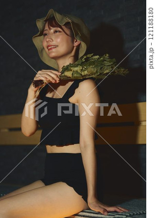 サウナでヴィヒタを使う女性　撮影協力・白玉の湯 泉慶 121188180