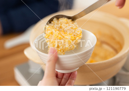 鶏の水炊き鍋のスープで雑炊（おじや）を楽しむミドル夫婦 121190779