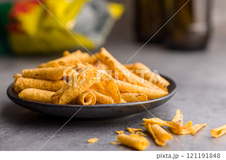 Rolled nachos tortilla chips on plate on kitchen table. Rolled nachos tortilla chips on plate on kitchen table. 121191848