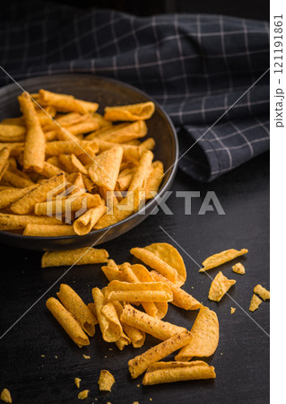 Rolled nachos tortilla chips on black table. Rolled nachos tortilla chips on black table. 121191861