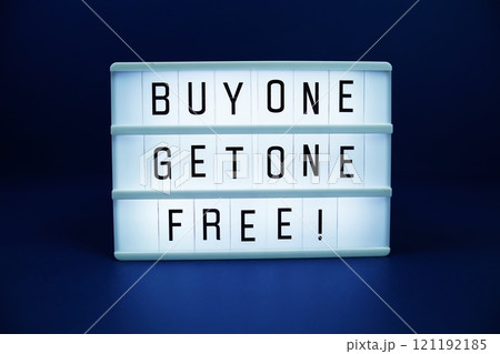 Buy one Get one Free! letterboard text on LED Lightbox on blue background Buy one Get one Free! letterboard text on LED Lightbox on blue background 121192185