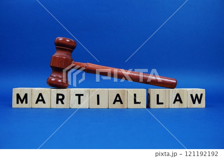 Martial Law alphabet letters with wooden blocks alphabet letters and Gavel on blue background 121192192