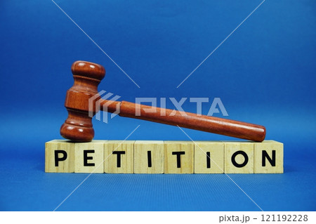 Petition alphabet letters with wooden blocks alphabet letters and Gavel on blue background 121192228