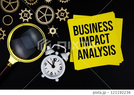 BIA - Business Impact Analysis text message on sticky note with magnifying glass and alarm clock on black background 121192236
