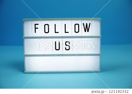 Follow Us letterboard text on LED Lightbox on blue background 121192332