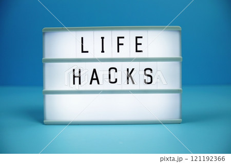 Life Hacks letterboard text on LED Lightbox on blue background Life Hacks letterboard text on LED Lightbox on blue background 121192366