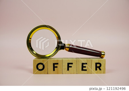 Offer with wooden blocks alphabet letters and Magnifying glass on pink background 121192496