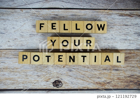 Fellow your potential with wooden blocks alphabet letterstop view on wooden background 121192729