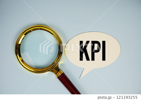 KPI text on speech bubble with magnifying glass top view on blue background 121193255