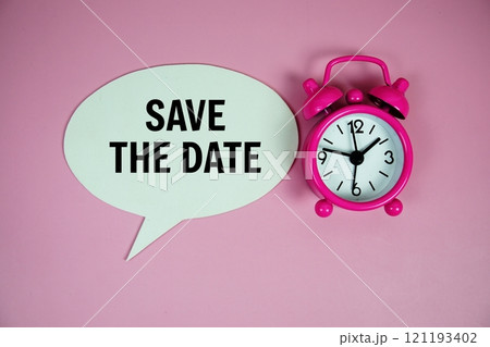 Save the date text on speech bubble with alarm clock top view on pink background Save the date text on speech bubble with alarm clock top view on pink background 121193402