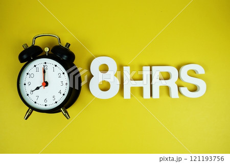 8 Hrs alphabet letters and alarm clock top view on yellow background 8 Hrs alphabet letters and alarm clock top view on yellow background 121193756