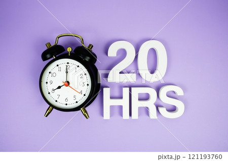 20 Hrs alphabet letters and alarm clock top view on purple background 121193760