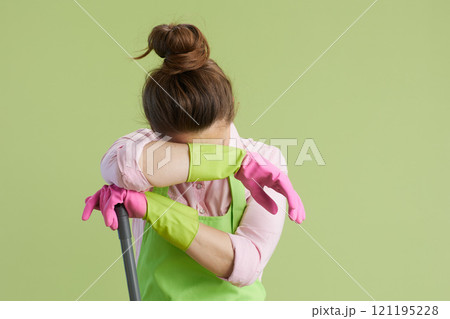 unhappy modern 40 years old housewife isolated on green unhappy modern 40 years old housewife isolated on green 121195228