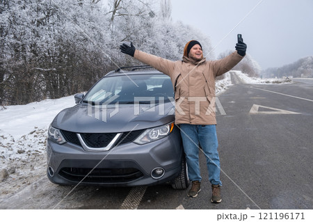 Man Taking Selfie with SUV on Snowy Roadside Man Taking Selfie with SUV on Snowy Roadside 121196171