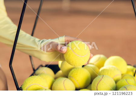 Close up of a basket with yellow tennis balls Close up of a basket with yellow tennis balls 121196223