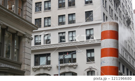 Steam vapor vented, New York City street steam system, orange vapour tube stack. Hot smoke from pipe 121196680