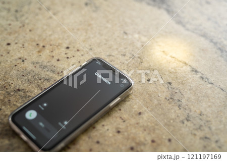 Fraud or fraudulent schemes. Close-up of a phone with an unexpected incoming call from an unknown person Fraud or fraudulent schemes. Close-up of a phone with an unexpected incoming call from an unknown person 121197169