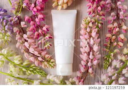 cosmetic moisturizer cream bottle tube and lupine flowers a lot. Shampoo, gel, skincare, facial cream, sunblock or sunscreen. white blank tube, template mockup cosmetic moisturizer cream bottle tube and lupine flowers a lot. Shampoo, gel, skincare, facial cream, sunblock or sunscreen. white blank tube, template mockup 121197259