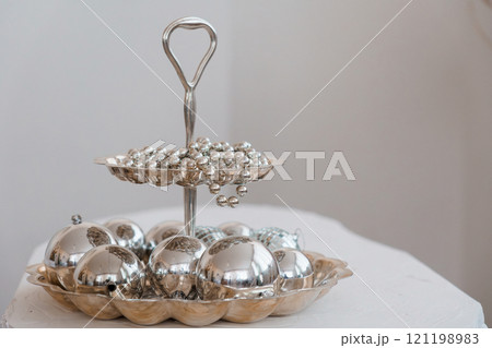 Elegant Silver Platter Displaying Polished Decorative Balls Elegant Silver Platter Displaying Polished Decorative Balls 121198983