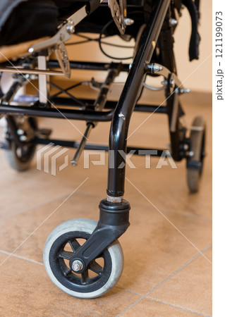 Detailed Close-Up of Wheelchair Wheel and Frame 121199073