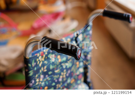 Close-up View of a Colorful Walker Handles in a Cozy Indoor Environment 121199154