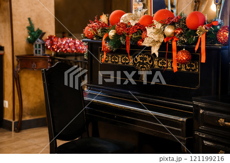 Elegant Christmas Decorated Piano in a Cozy Festive Room 121199216