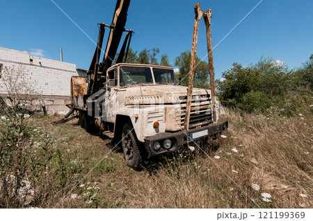 Abandoned Construction Truck Surrounded by Overgrown Vegetation Abandoned Construction Truck Surrounded by Overgrown Vegetation 121199369