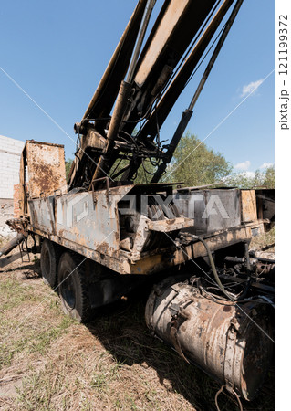 Abandoned Hydraulic Crane in an Overgrown Field 121199372