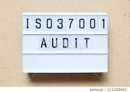 Lightbox with word ISO 37001 audit on wood background 121200442