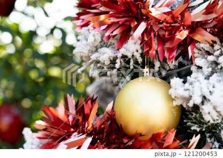 Background of gold decoration ball on christmas tree with another ornament Background of gold decoration ball on christmas tree with another ornament 121200453