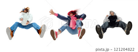 Three stylish young people in creative low-angle poses, in modern street fashion outfits and bold footwear against white background. Bottom view Three stylish young people in creative low-angle poses, in modern street fashion outfits and bold footwear against white background. Bottom view 121204822