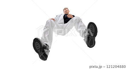 Bottom view image of fashionable young man in white pants and black sneakers, showcasing energy and modern sporty style. Comfort and confidence 121204880