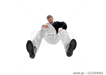 Happy young man wearing black and white casual sportswear and glasses, posing with joy. Bottom view. Modern style and active lifestyle 121204881
