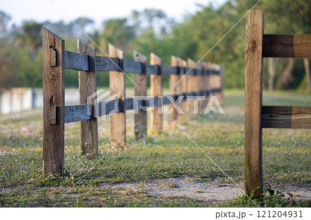 Wooden fence barrier at farm grounds for cattle and territory protection 121204931