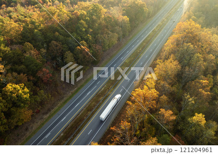 Wide multilane highway road in USA Appalachian mountains with fast driving semi trucks. Above view of American transportation infrastructure Wide multilane highway road in USA Appalachian mountains with fast driving semi trucks. Above view of American transportation infrastructure 121204961
