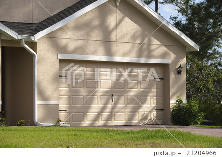 Wide garage double door and concrete driveway of new modern american house 121204966