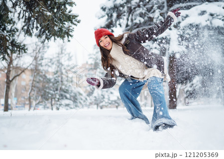 Beautiful Woman Wearing Fashionable Winter Clothes walking in winter nature. Holidays concept. 121205369