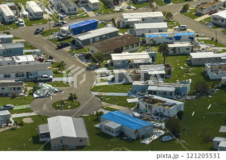 Severely damaged houses after hurricane Ian in Florida mobile home residential area. Consequences of natural disaster Severely damaged houses after hurricane Ian in Florida mobile home residential area. Consequences of natural disaster 121205531