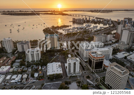 Sarasota, Florida at sunset. Luxury yachts docked in Sarasota Bay marina. American city downtown architecture with high-rise office buildings. USA travel destination Sarasota, Florida at sunset. Luxury yachts docked in Sarasota Bay marina. American city downtown architecture with high-rise office buildings. USA travel destination 121205568
