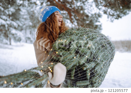 Smiling woman in a bright hat enjoying a winter day outdoors. Holiday, nature concept. Smiling woman in a bright hat enjoying a winter day outdoors. Holiday, nature concept. 121205577