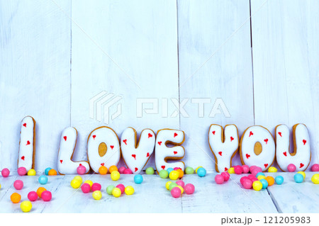 Homemade cookies in the form of a heart or I love you words as a gift to a beloved on Valentine's Day. Homemade cookies in the form of a heart or I love you words as a gift to a beloved on Valentine's Day. 121205983